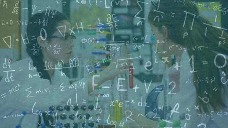 Image of mathematical equations over caucasian schoolgirls with models in classroom. school and education concept digitally generated image. 