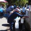 woman filling water bottle