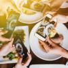 Group of friends going out and taking a photo of Italian food together with mobile phone