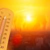 Thermometer showing high temperature against a burning background