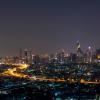 City scape of skyscrapers with lights on in the offices by night