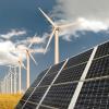 Solar panels in front of wind energy plants