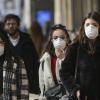 Coronavirus emergency in Milan, citizens and tourists stroll through the city center wearing protective masks