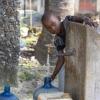 African child fills water