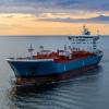 Tanker at sea, aerial view. Large blue and white ship in the bay at sunset