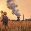 Father with son looking at chemical plant emissions in the sunset