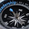 Compass with needle pointing to the word leadership