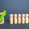 Wooden figures queing in front of green vote check mark.