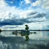 Submerged house in flood waters on a cloudy day