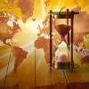 Conceptual image with an hourglass and a world map 