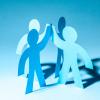 paper cut-out figures on blue background give high five