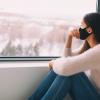 Woman wearing face mask indoors at home for social distancing