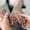 Close up oftwo people's hands - one elderly and one younger