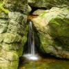 Mountain spring water flowing out of a rock