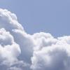 Panorama of white fluffy cumulus clouds 