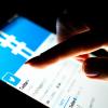 Close-up of someone's finger clicking on Twitter app on a tablet