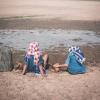 Boy and girl sitting on cracked dry ground, Concept drought and shortage of water crisis 