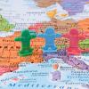 People figurines on a map of Western Europe
