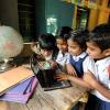 Indian school children looking at laptop