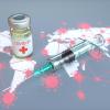 Conceptual image of COVID-19 vaccine and COVID infection on a world map