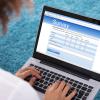 Woman completing an online survey on a laptop