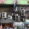 Air conditioning units on the outside of a building in Hong Kong above shops.