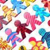 Colorful paper-people cutouts holding hands