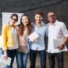 Multicultural group of young people standing in an office