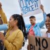 Young people protesting climate change with megaphone and posters