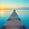 Footbridge going of into the distance over calm water
