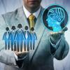 Unrecognizable male business manager raising artificial intelligence above a work team. Technology concept for AI, machine and deep learning, robolution, digital transformation of the workforce.