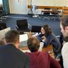 Participants at the meeting gatherd around a laptop
