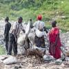 African people collecting recyclables from trash.