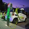 Mini electric cars at electric charging station in city of Frankfurt at night. 