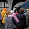 War in Ukraine. Little girl on mom`s shoulder. Refugees from the evacuation train from Mariupol, Berdyansk, Kryvyi Rih