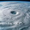 A hurricane swirling with immense power, representing the intensification of extreme weather events