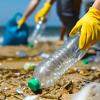 People picking up litter on a sandy beach