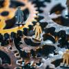 A conceptual art piece featuring gears containing people, representing the role of human capital in business operations. AI generated
