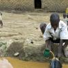 Children fetching water from well in Uganda