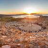 The ancient Delos Theatre  against the sunset