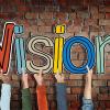 Group of Hands Holding Letter Vision