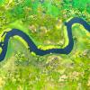 Aerial view of river meander in the lush green vegetation of the delta
