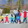 Adults Escorting Children Safely. Adults guide pre-school children across a crosswalk using a safety line in Chilliwack, BC, Canada on January 8, 2019.