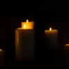 Candles burning against a dark background