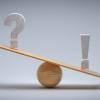 Wooden scale balancing a question mark and an exclamation mark tipping more the right side - 3d illustration. 
