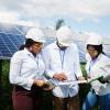 Group of three African engineers meeting at solar station 