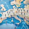 Global connectivity network representation, miniature figures on map of Europe, illustrating social connections and interactions
