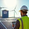 Engineer monitoring renewable energy: solar panels, wind turbines, and hydrogen storage