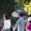 Hot summers day in Istanbul, Turkey, people walking in sun with umbrella