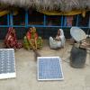 A solar plate being charged in front of a house.